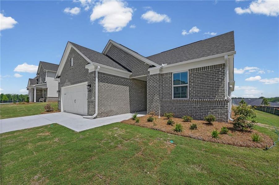 Front exterior of a new home in Overland, Locust Grove, GA, highlighting curb appeal (Image 2). Front exterior of a new home in Overland, Locust Grove, GA, highlighting curb appeal (Image 2).