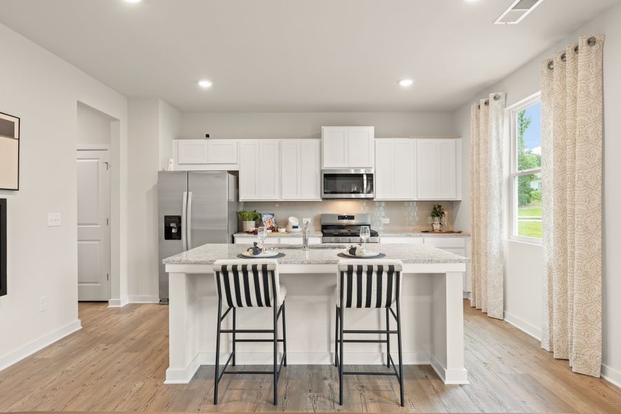 A kitchen with white cabinets. A kitchen with white cabinets.