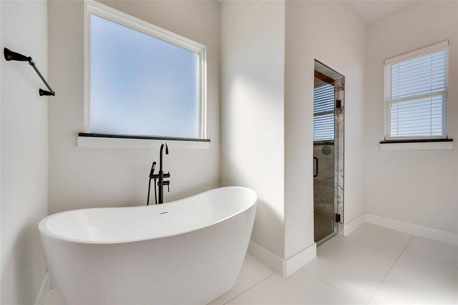 Bathroom featuring plus walk in shower and tile patterned floors