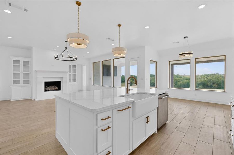 Expansive kitchen island with a farmhouse sink and quartz countertop Expansive kitchen island with a farmhouse sink and quartz countertop