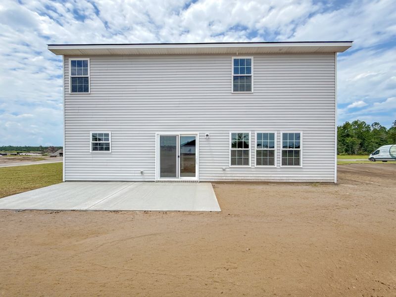 Exterior details and patio area of a home in The Village at Sassafras, Allenhurst (Image 2).
