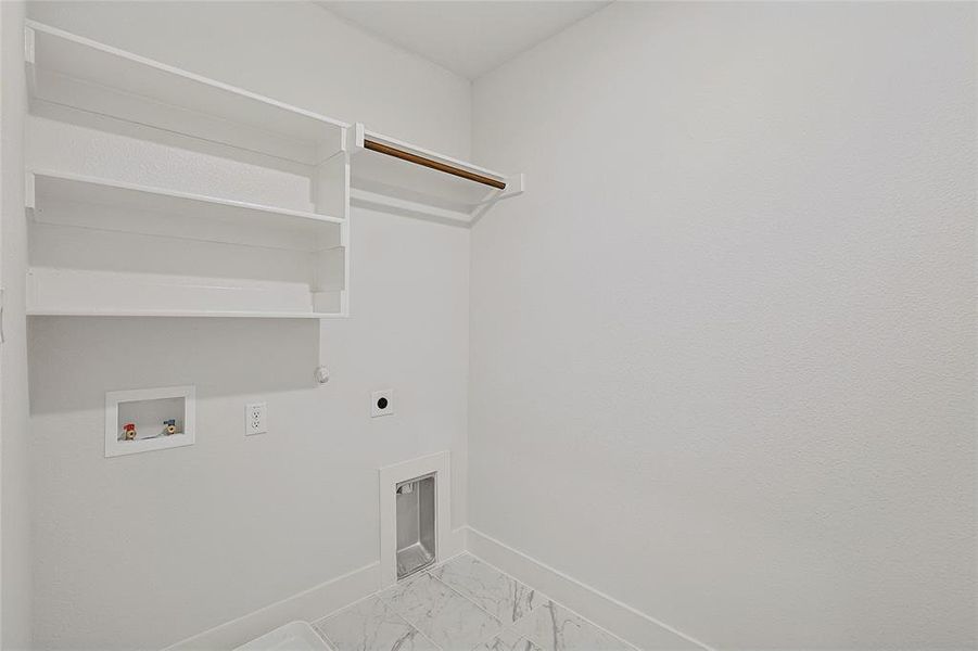 Well-appointed laundry area with built-in shelving, a hanging rod, and marble-patterned flooring