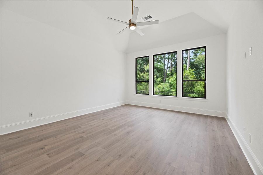 Retreat to this serene primary suite featuring soaring ceilings, tranquil treetop views, and lots of natural light