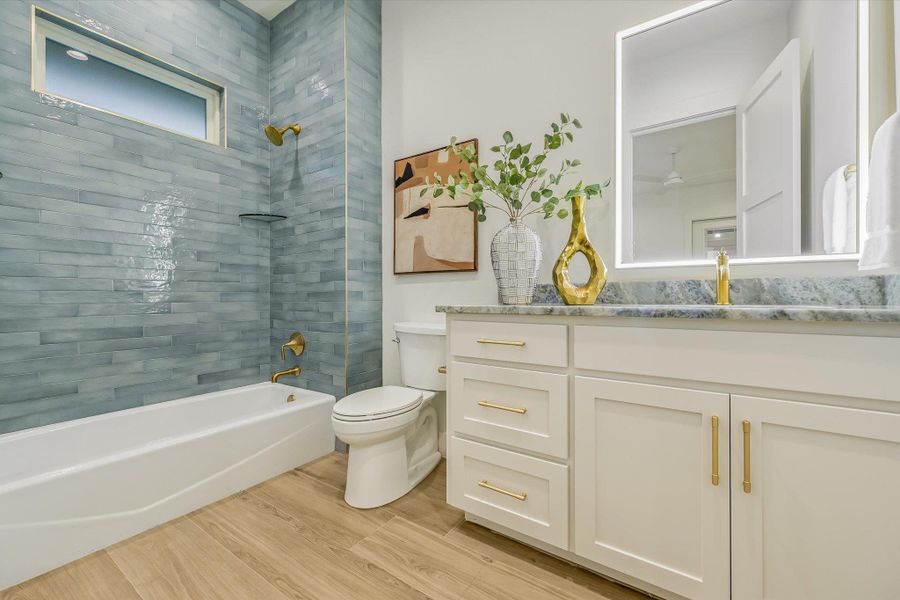 Bathroom with vanity,  shower combination, and light wood-style flooring