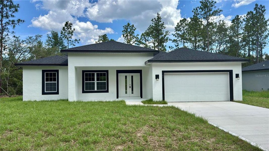 Front exterior of a new home in , Citrus Springs, FL, highlighting curb appeal (Image 1).
