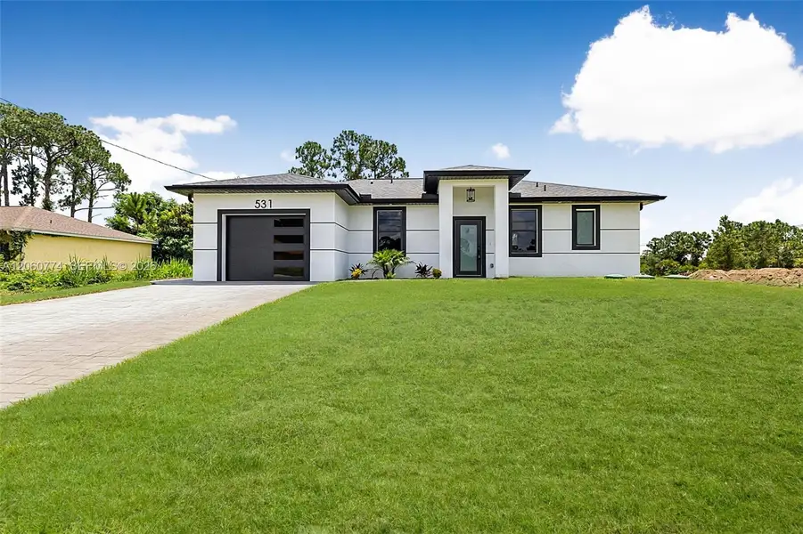 Front exterior of a new home in , Lehigh Acres, FL, highlighting curb appeal (Image 20). Front exterior of a new home in , Lehigh Acres, FL, highlighting curb appeal (Image 20).