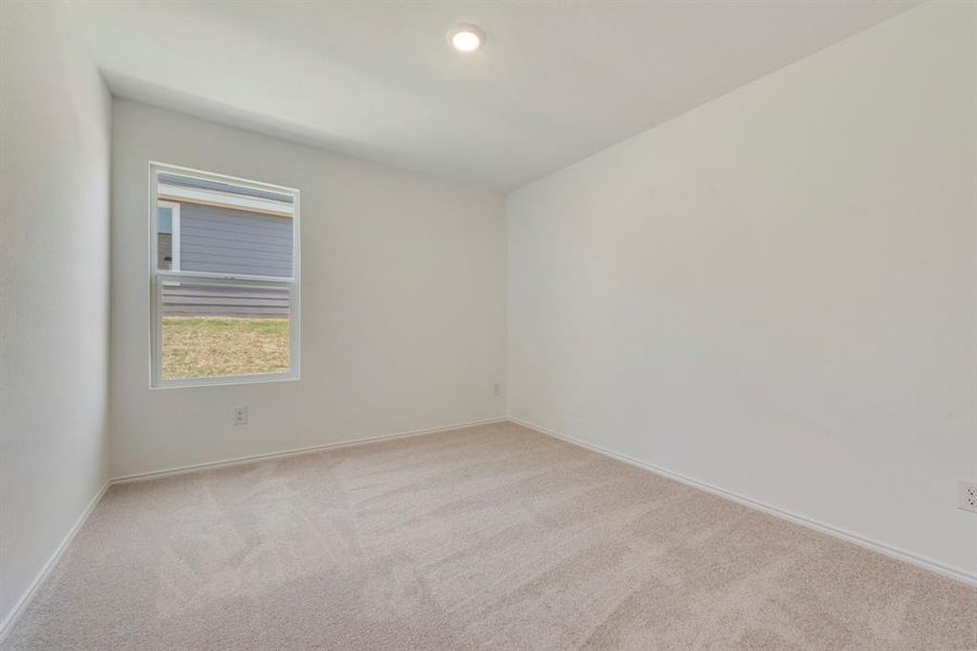 Empty room featuring light colored carpet