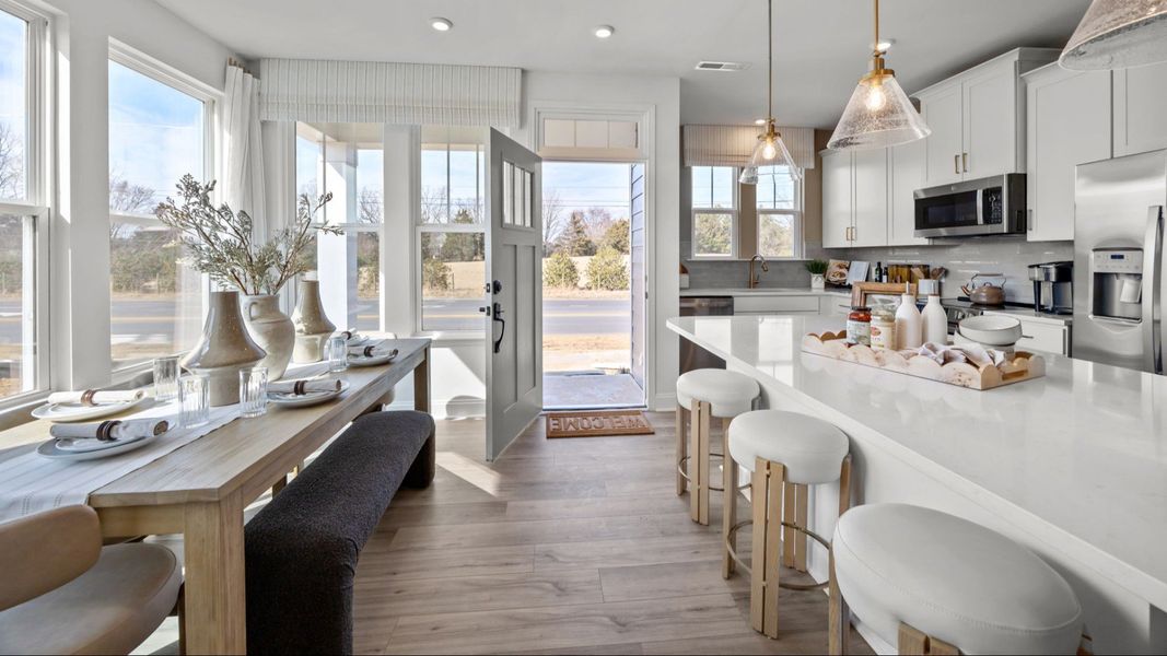 The Rochester Plan by DRB homes modern kitchen & cozy dining area in Charlotte, NC.