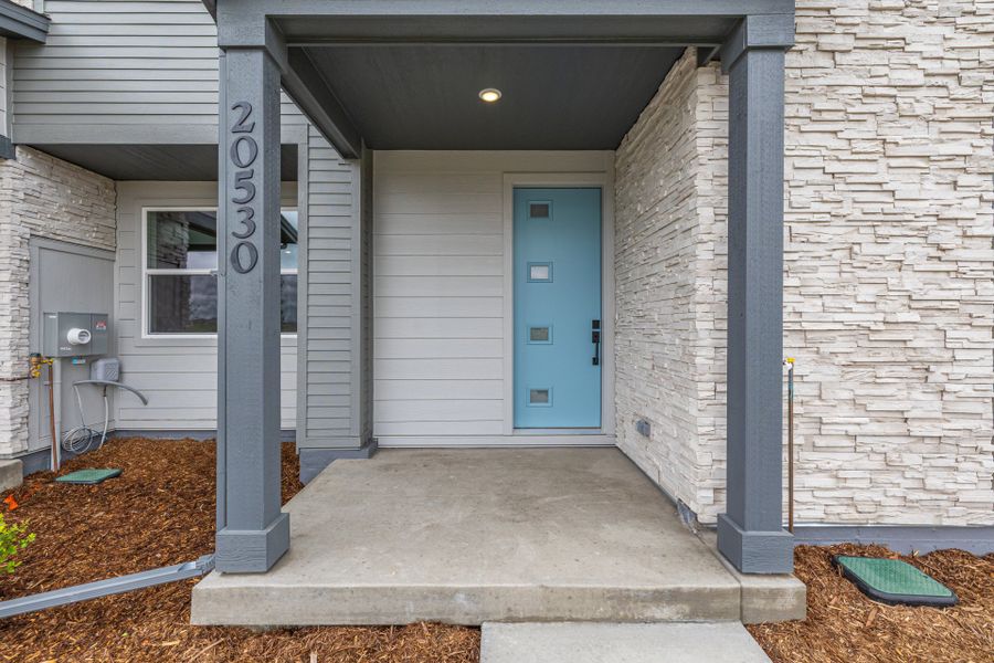 Front exterior of a new home in Painted Prairie, Aurora, CO, highlighting curb appeal (Image 25).