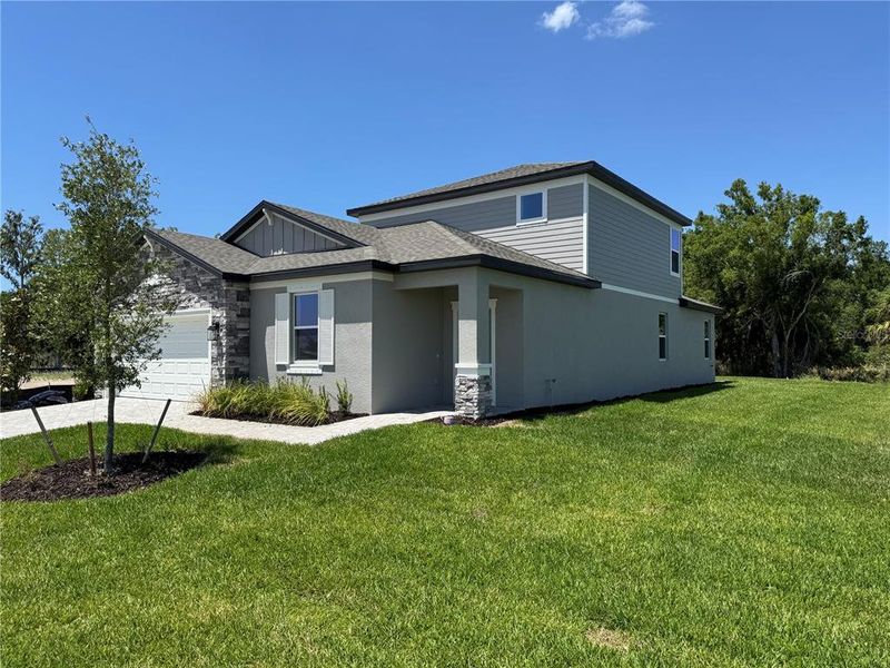 Front exterior of a new home in Southpointe, Palmetto, FL, highlighting curb appeal (Image 17).