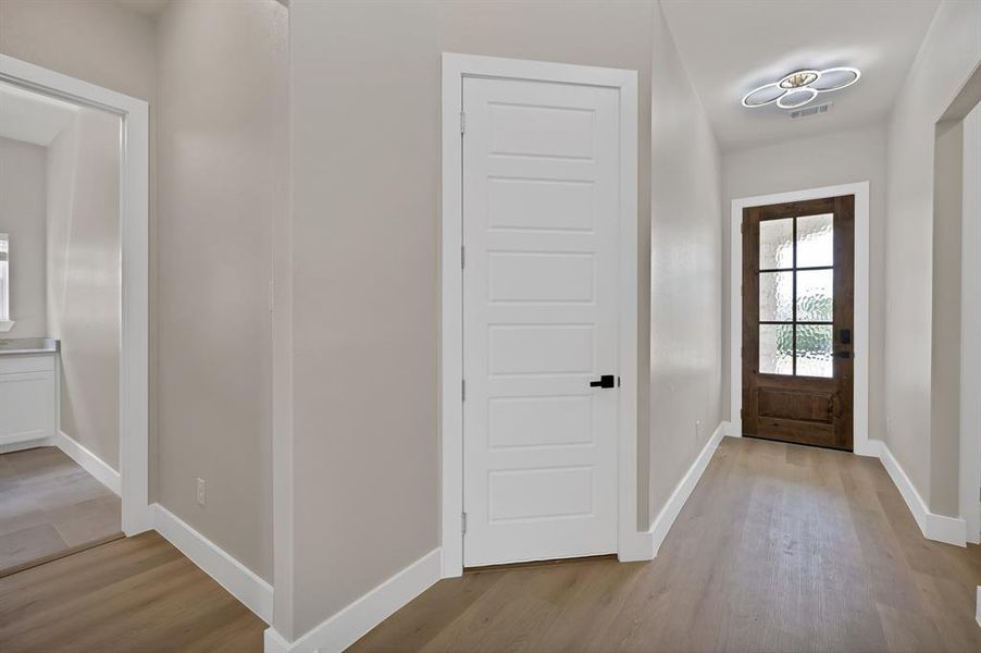 Foyer entrance featuring light wood-style flooring and baseboards Foyer entrance featuring light wood-style flooring and baseboards