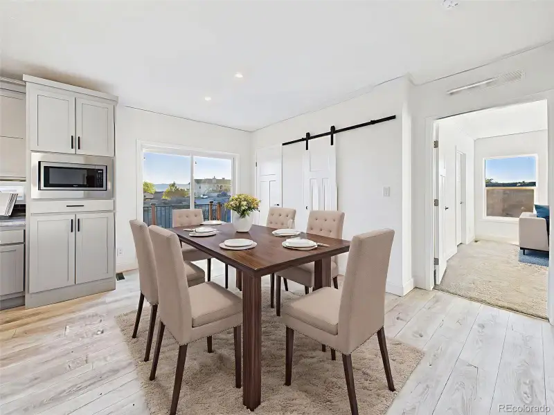 Virtually Staged dining area showing seamless flow to the kitchen and deck with lake views. Virtually Staged dining area showing seamless flow to the kitchen and deck with lake views.