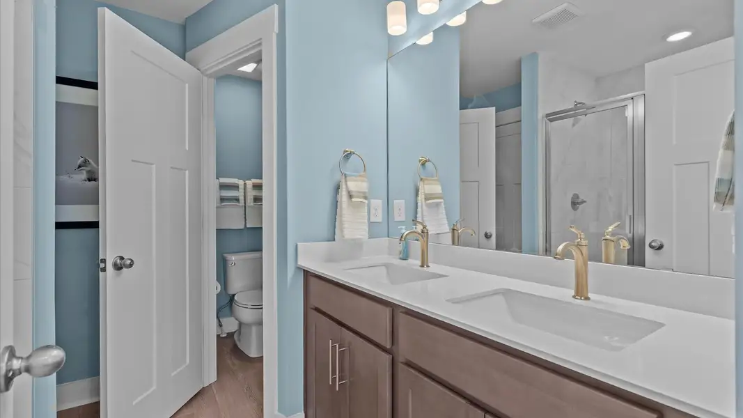 Exceptional en-suite with dual vanity and glass-enclosed walk-in shower for superior everyday comfort at Marion Square