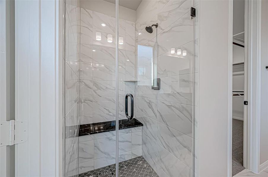 Both bathrooms feature mud-set showers with benches and spacious walk-in closets with shelving and abundant hanging space.