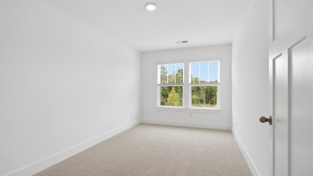 Accomplished bedroom layout with cozy carpet, a spacious walk-in closet, and sun-filled windows at Marion Square Accomplished bedroom layout with cozy carpet, a spacious walk-in closet, and sun-filled windows at Marion Square