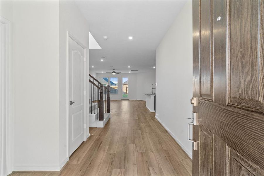 Welcome to your new home at 3042 Kastania Lane. You are greeted with this beautiful entryway featuring vinyl plank flooring, recessed lighting, and custom paint.