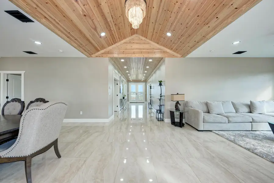 Polished tile flooring and an intricate wood-clad ceiling define this open, airy layout. Polished tile flooring and an intricate wood-clad ceiling define this open, airy layout.