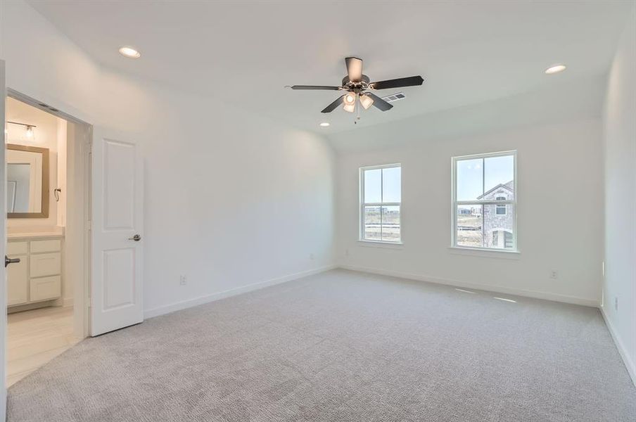 Spare room featuring ceiling fan and light colored carpet