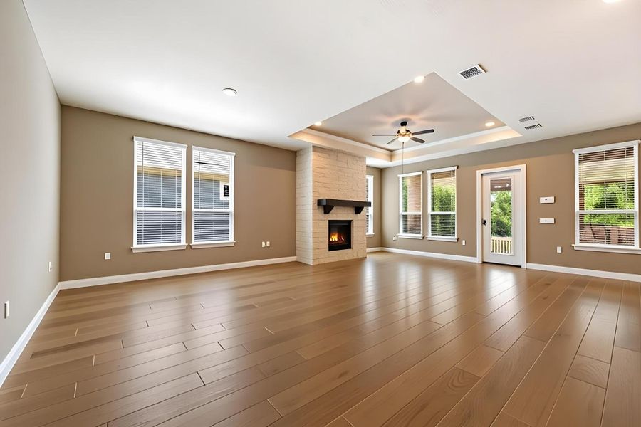 A spacious great room boasts warm wood flooring and a charming fireplace, perfect for gatherings. A spacious great room boasts warm wood flooring and a charming fireplace, perfect for gatherings.