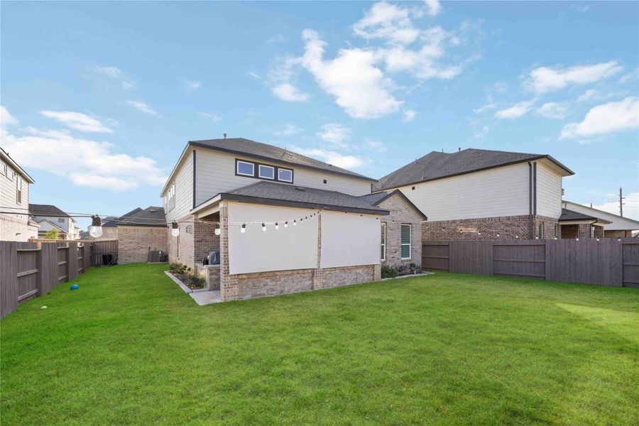 Covered back patio featuring a retractable privacy shade, offering comfort and seclusion for outdoor living. Covered back patio featuring a retractable privacy shade, offering comfort and seclusion for outdoor living.