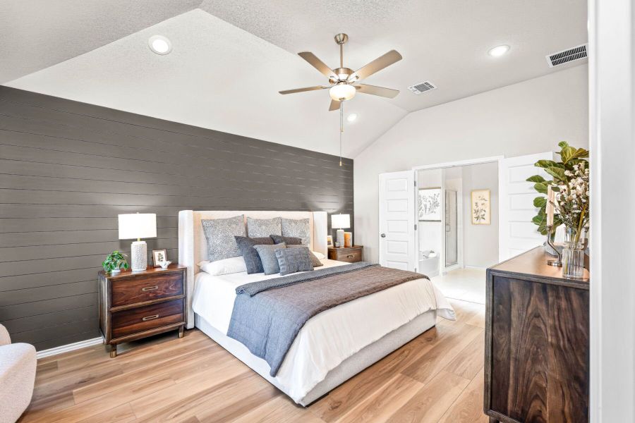 Primary bedroom in the model home located in Carillon at 13305 Eppright Trace Blvd., Manor, TX Primary bedroom in the model home located in Carillon at 13305 Eppright Trace Blvd., Manor, TX
