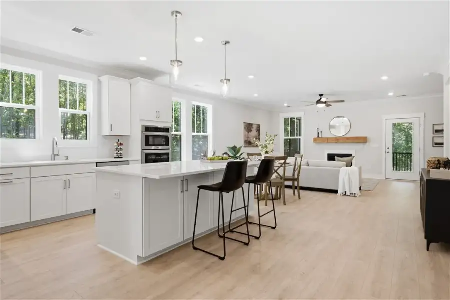 Gleaming hardwood floors run through this airy ope