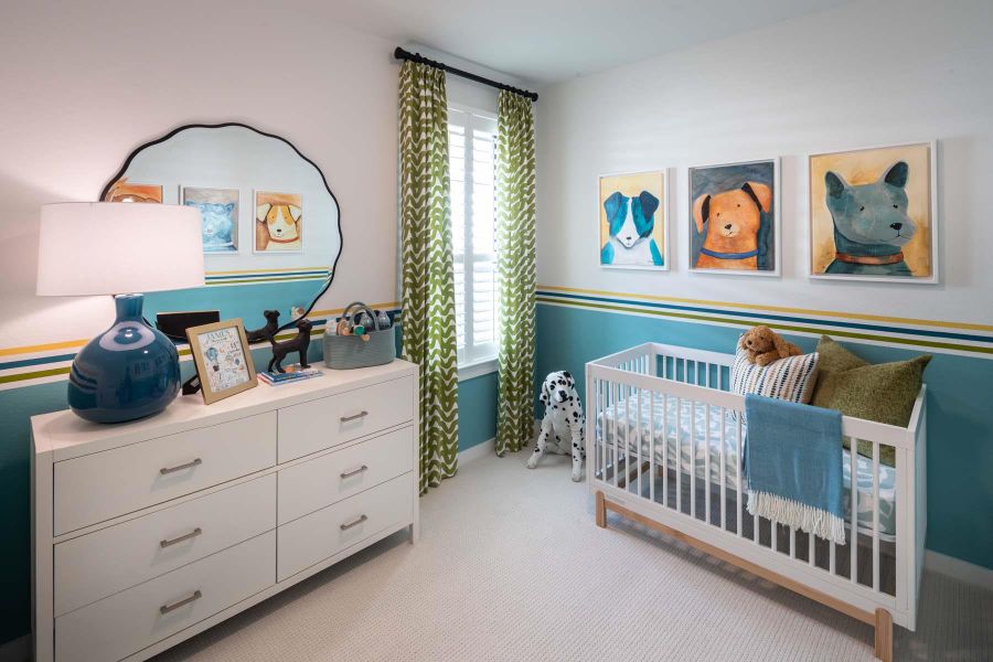 Bedroom with a crib, light colored carpet, and baseboards