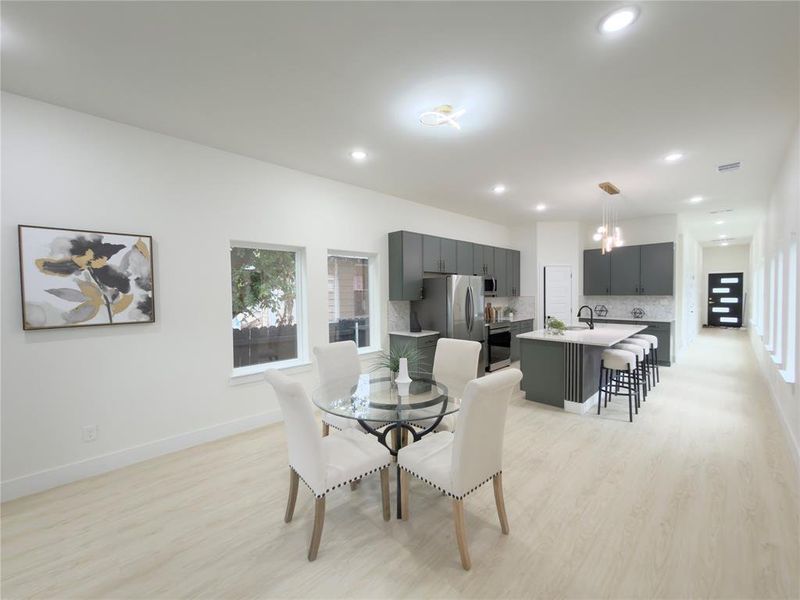 Dining room featuring light wood-style flooring and recessed lighting