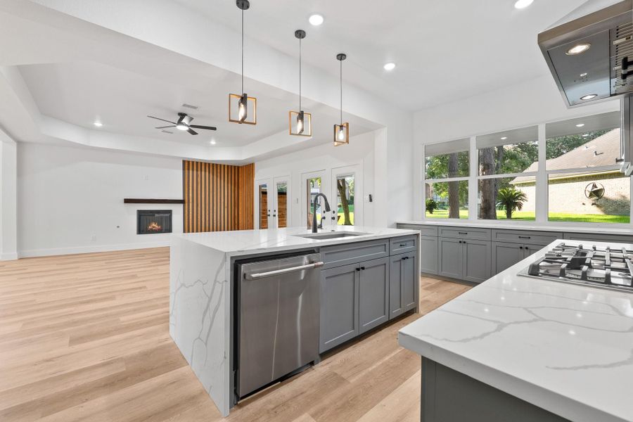 This bright kitchen seamlessly connects to the living room and features custom cabinetry and a sleek stainless steel appliance package. This bright kitchen seamlessly connects to the living room and features custom cabinetry and a sleek stainless steel appliance package.