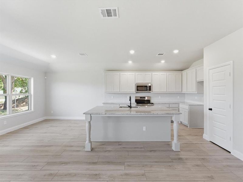 Open-concept living area with a kitchen island Open-concept living area with a kitchen island
