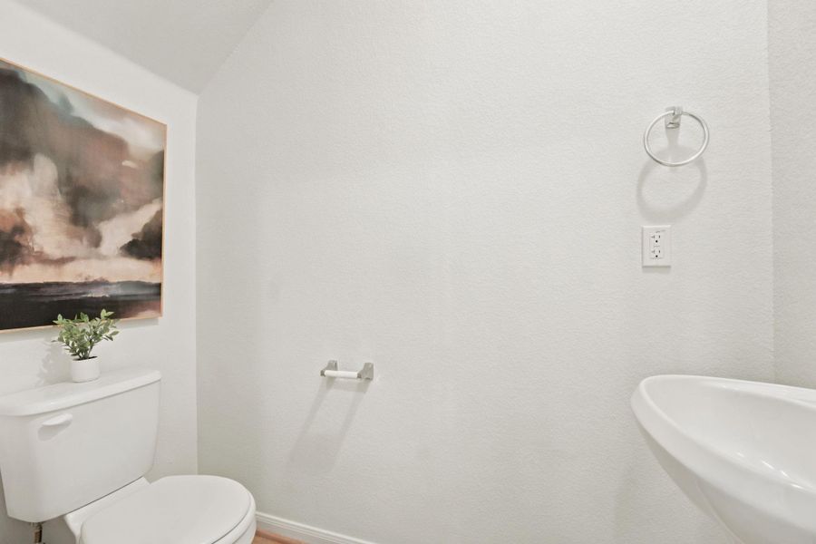 Crisp neutral walls and updated fixtures define this functional half bath.