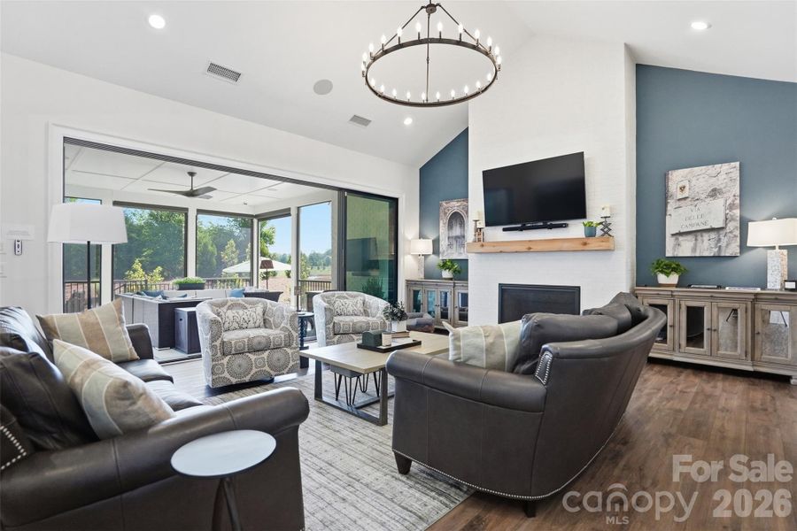 Great room with open sliders to screened porch with motorized screens