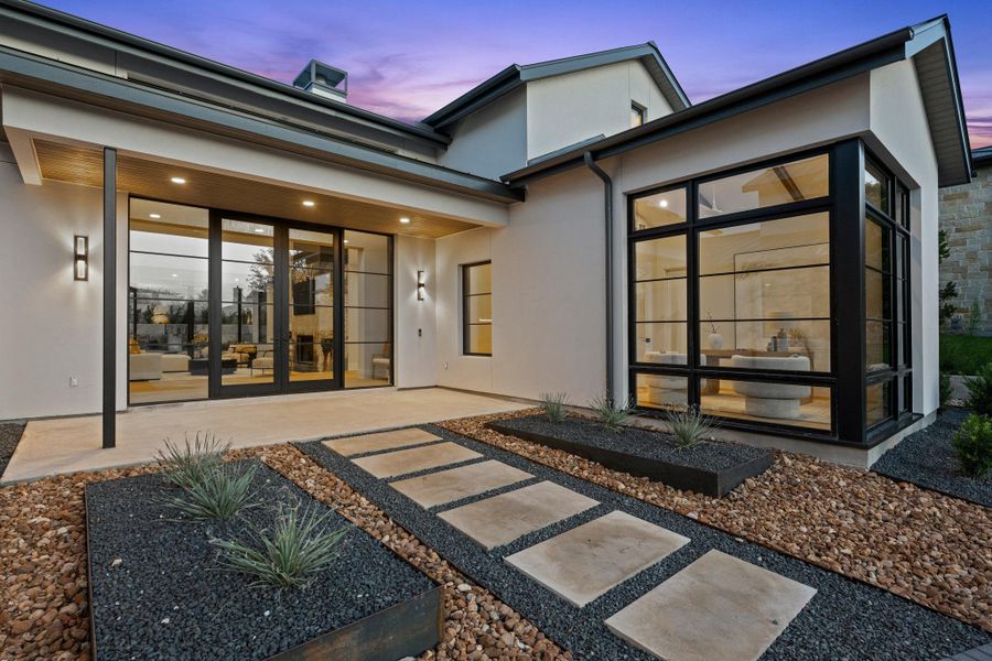 Impeccable curb appeal sets the stage for a residence that balances grand scale with sophisticated, manicured privacy
