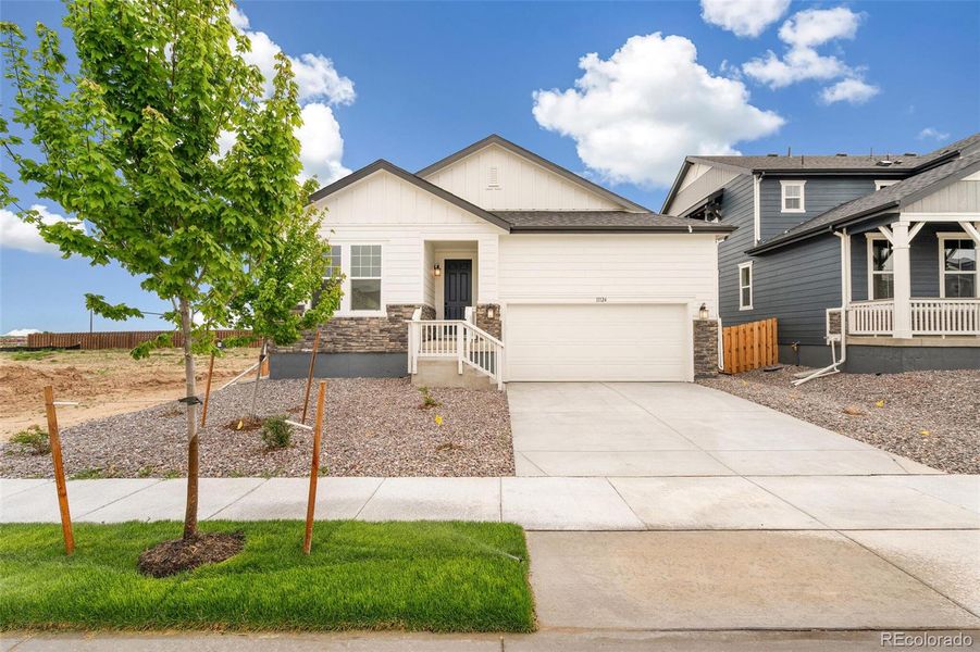 Front exterior of a new home in Turnberry, Commerce City, CO, highlighting curb appeal (Image 19).