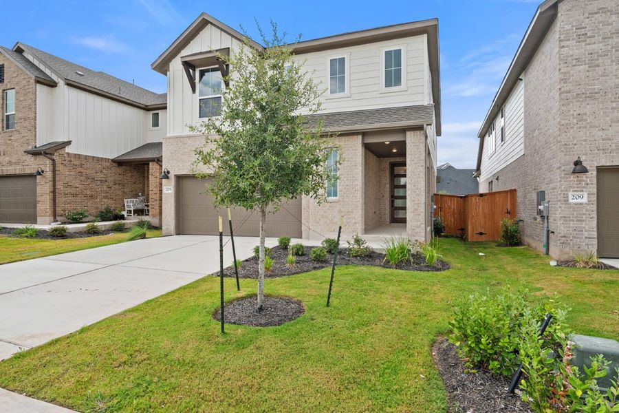 Front exterior of a new home in Terrace Collection at Lariat, Liberty Hill, TX, highlighting curb appeal (Image 2). Front exterior of a new home in Terrace Collection at Lariat, Liberty Hill, TX, highlighting curb appeal (Image 2).