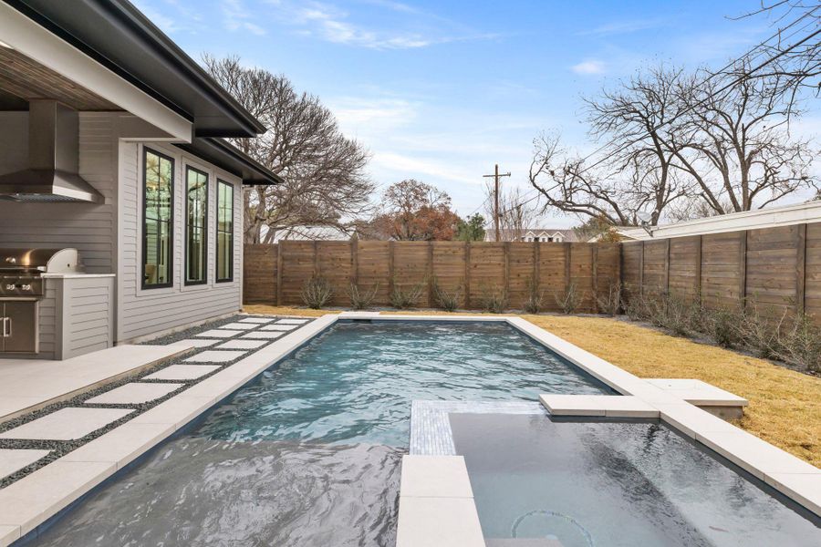 View of pool with a fenced backyard, an in-ground hot tub, and a patio area