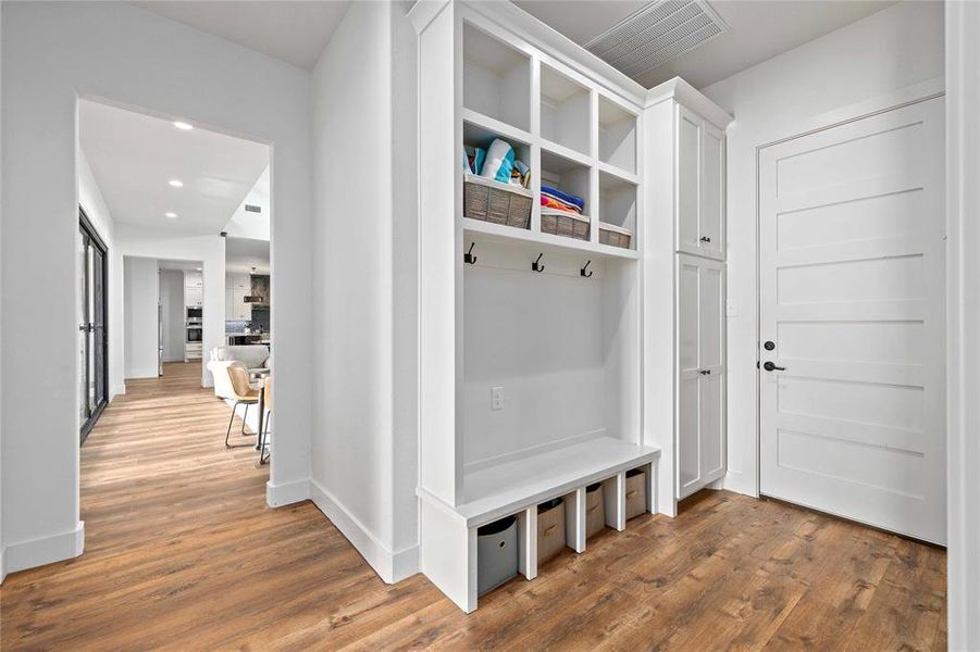 Mudroom with wood finished floors and recessed lighting