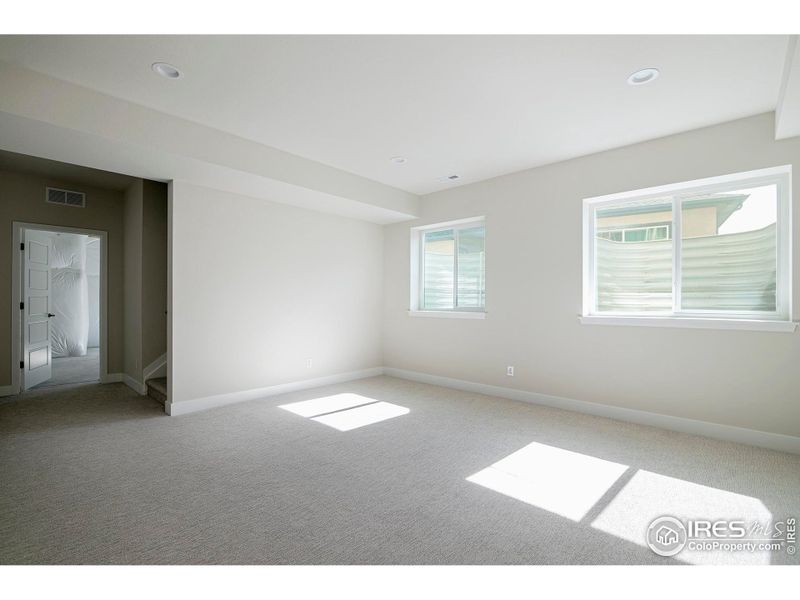 Lower level recreation room with daylight egress windows