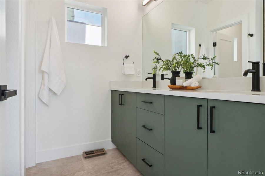 Ensuite bathroom in Primary bedroom (back unit layout), with double vanities, spa style shower, and separate toilet room. Finishes vary by unit