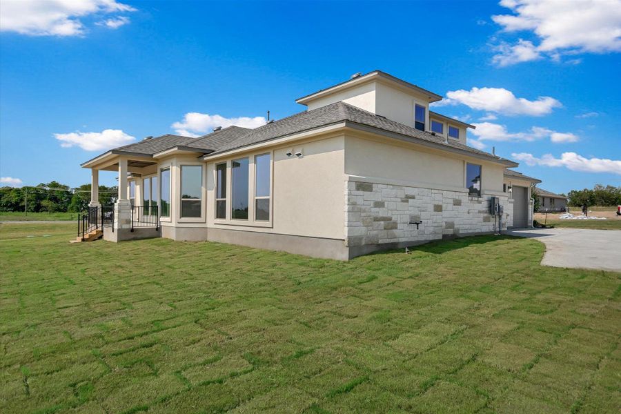 Front exterior of a new home in Scofield Farms Estates, Georgetown, TX, highlighting curb appeal (Image 11).