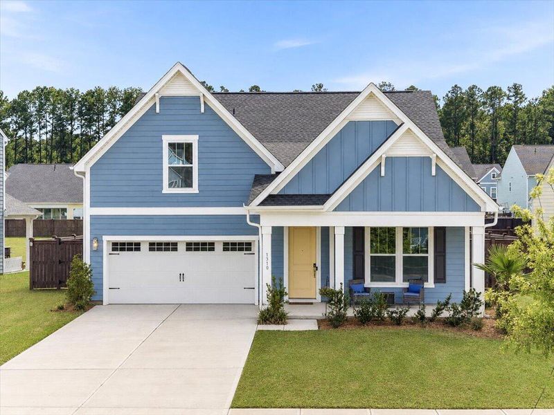 Front exterior of a new home in Homecoming, Ravenel, SC, highlighting curb appeal (Image 26). Front exterior of a new home in Homecoming, Ravenel, SC, highlighting curb appeal (Image 26).