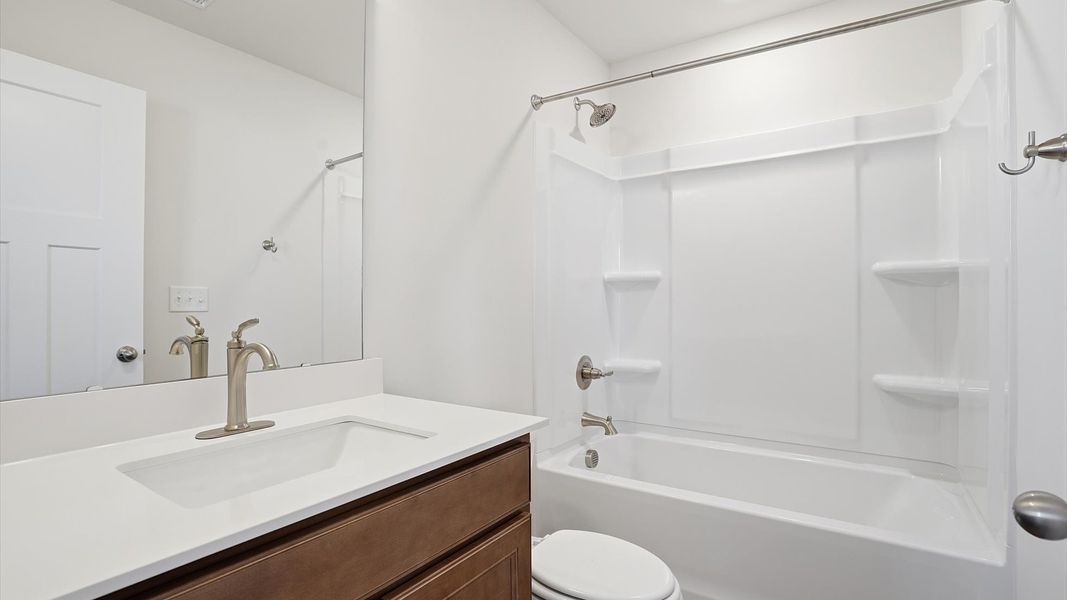Stylish guest bathroom with superior design and thoughtful storage solutions at Benjamin's Grove Stylish guest bathroom with superior design and thoughtful storage solutions at Benjamin's Grove