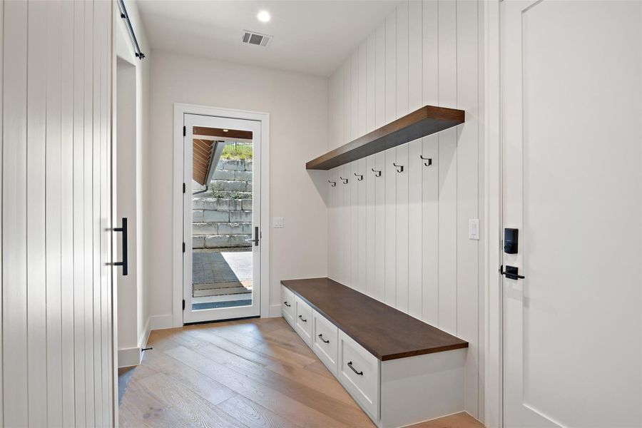 Mudroom featuring light wood finished floors and recessed lighting