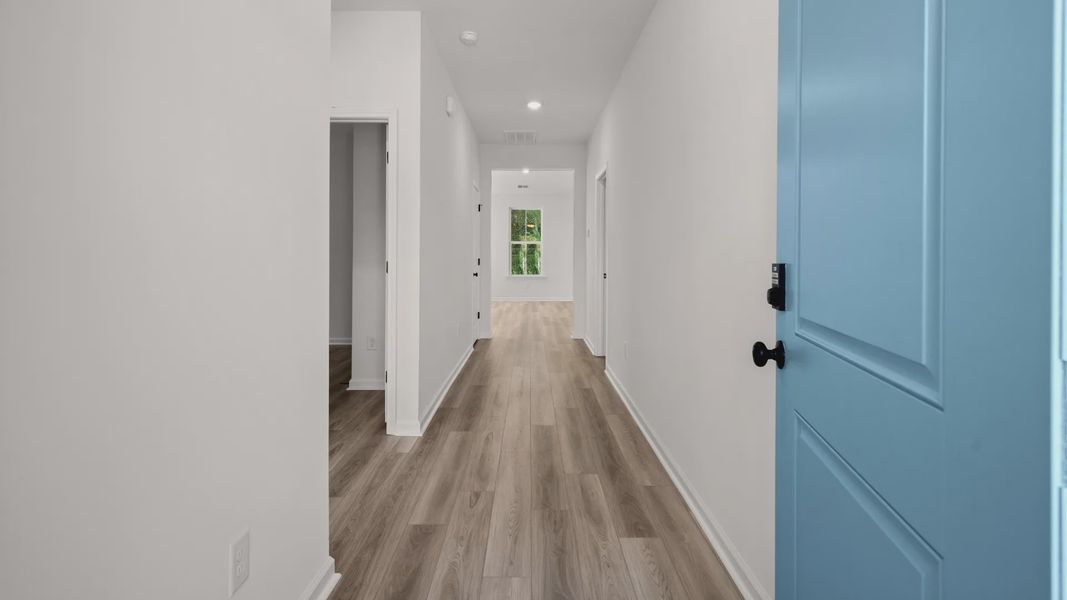 A welcoming entryway sets the tone with durable LVP floors and a light-filled path