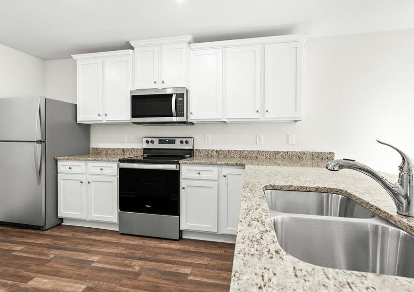 Kitchen with stainless steel appliances and granite countertops.