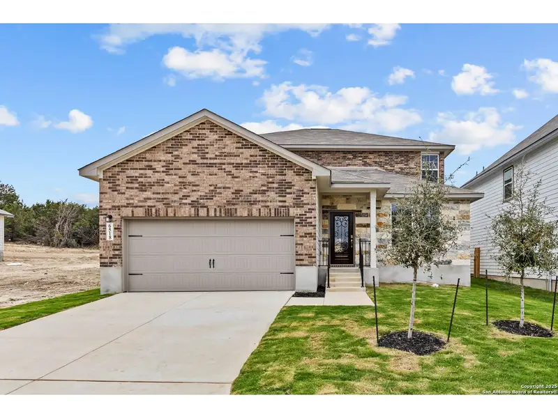 Front exterior of a new home in Royal Crest, San Antonio, TX, highlighting curb appeal (Image 1).