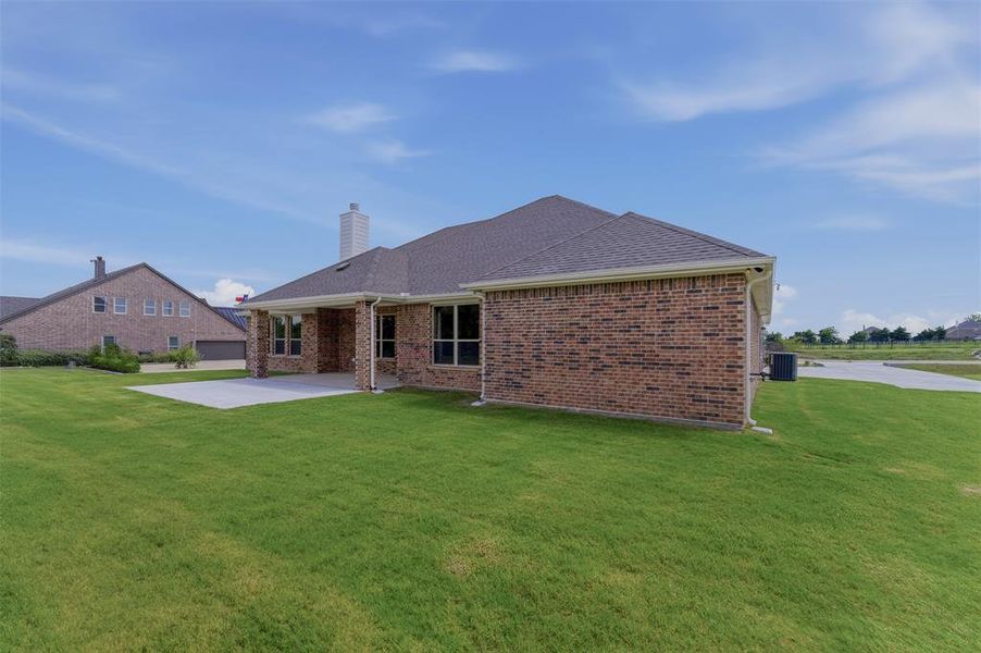 Expansive green lawn bordering a brick exterior residence Expansive green lawn bordering a brick exterior residence