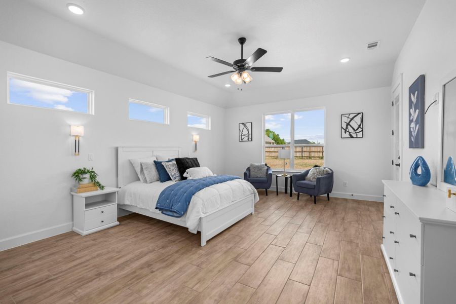 Bedroom featuring wood finish floors, ceiling fan, and recessed lighting