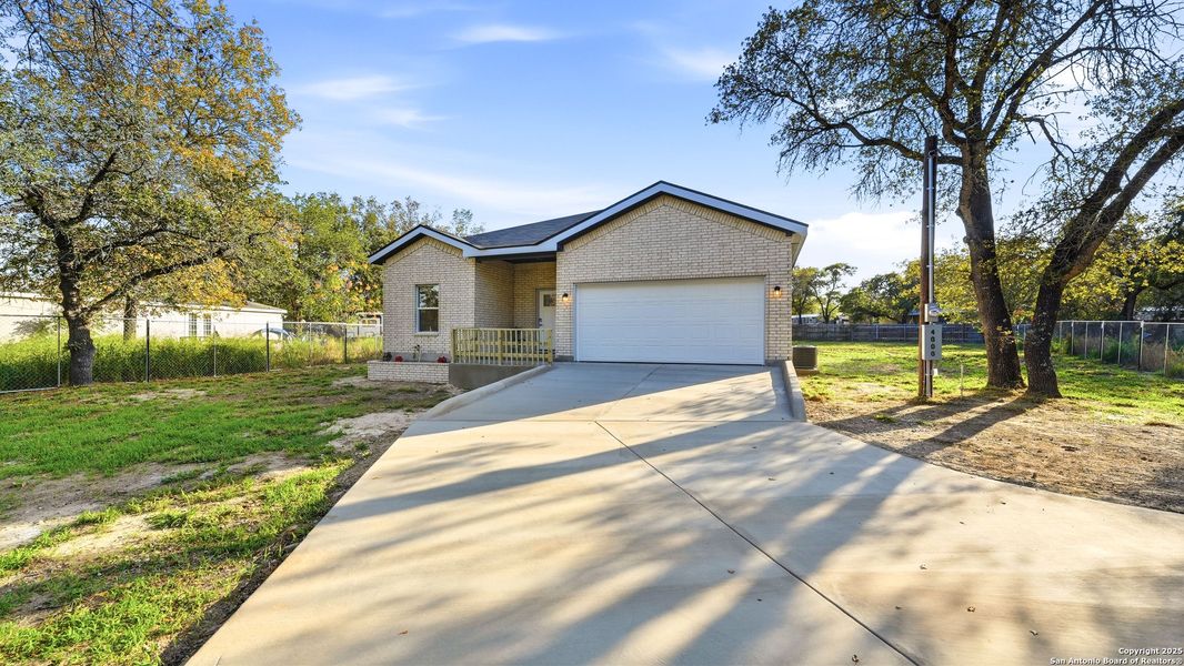 Front exterior of a new home in , Elmendorf, TX, highlighting curb appeal (Image 1).