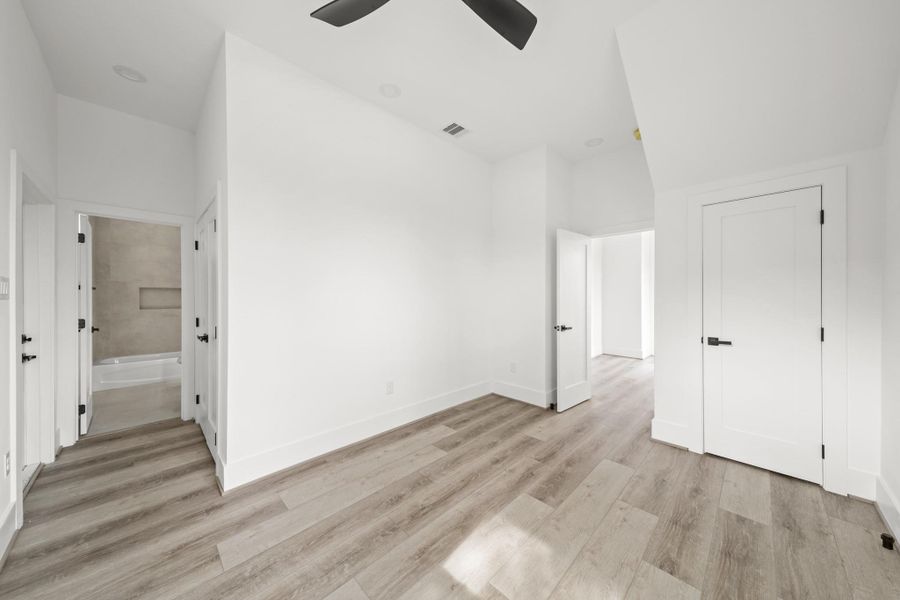 This bright room features luxury vinyl floors, tall baseboards and a closet under the stairs for additional storage to the right. This bright room features luxury vinyl floors, tall baseboards and a closet under the stairs for additional storage to the right.